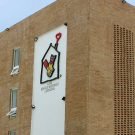 El programa Casa Ronald McDonald en Cartagena; el logo del programa aparece en la parte de adelante del edificio de ladrillo.